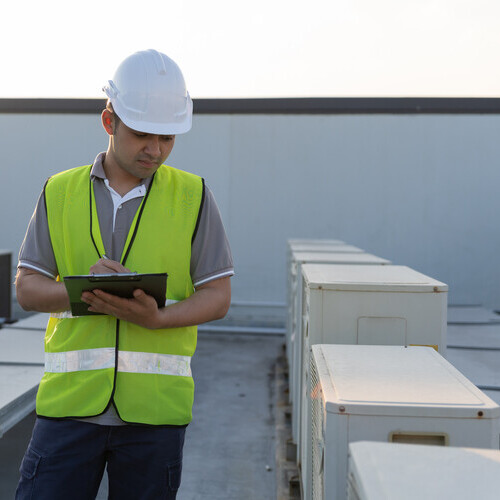 worker providing commercial roof inspection