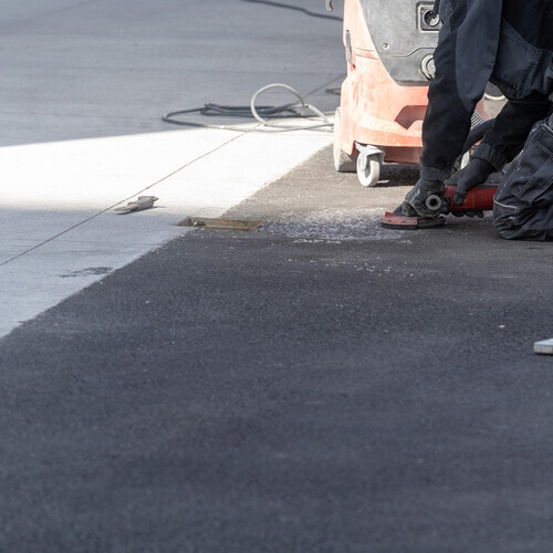worker repairing a commercial roofing system