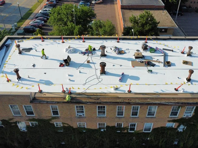 workers on a commercial roofing system