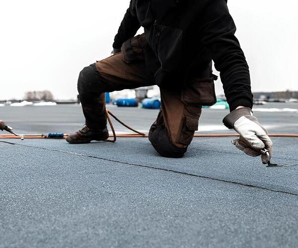 worker repairing a modified bitumen roof