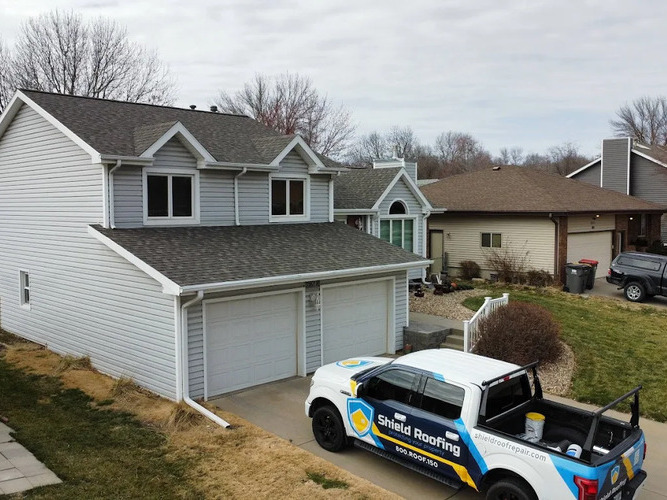 roofing contractor in front of a home