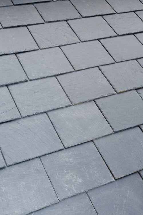 Detail of gray slate roof tiles on a pitched roof