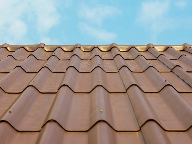 house with tiled roof on blue sky background